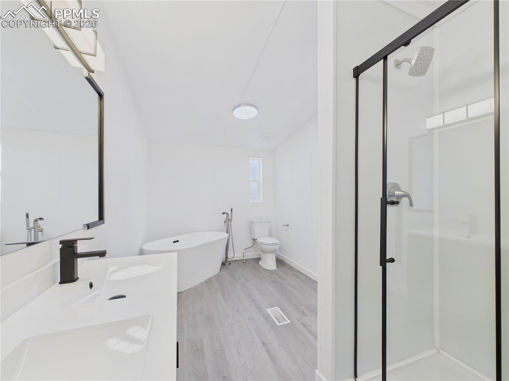 Completed bathroom with soaking tub and glass shower